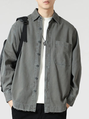 Grey oversized button-up long-sleeve shirt with chest pocket and frayed hem