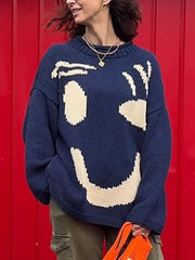 Dark blue knit sweater with abstract cream graphic face pattern, crew neck, long sleeves.