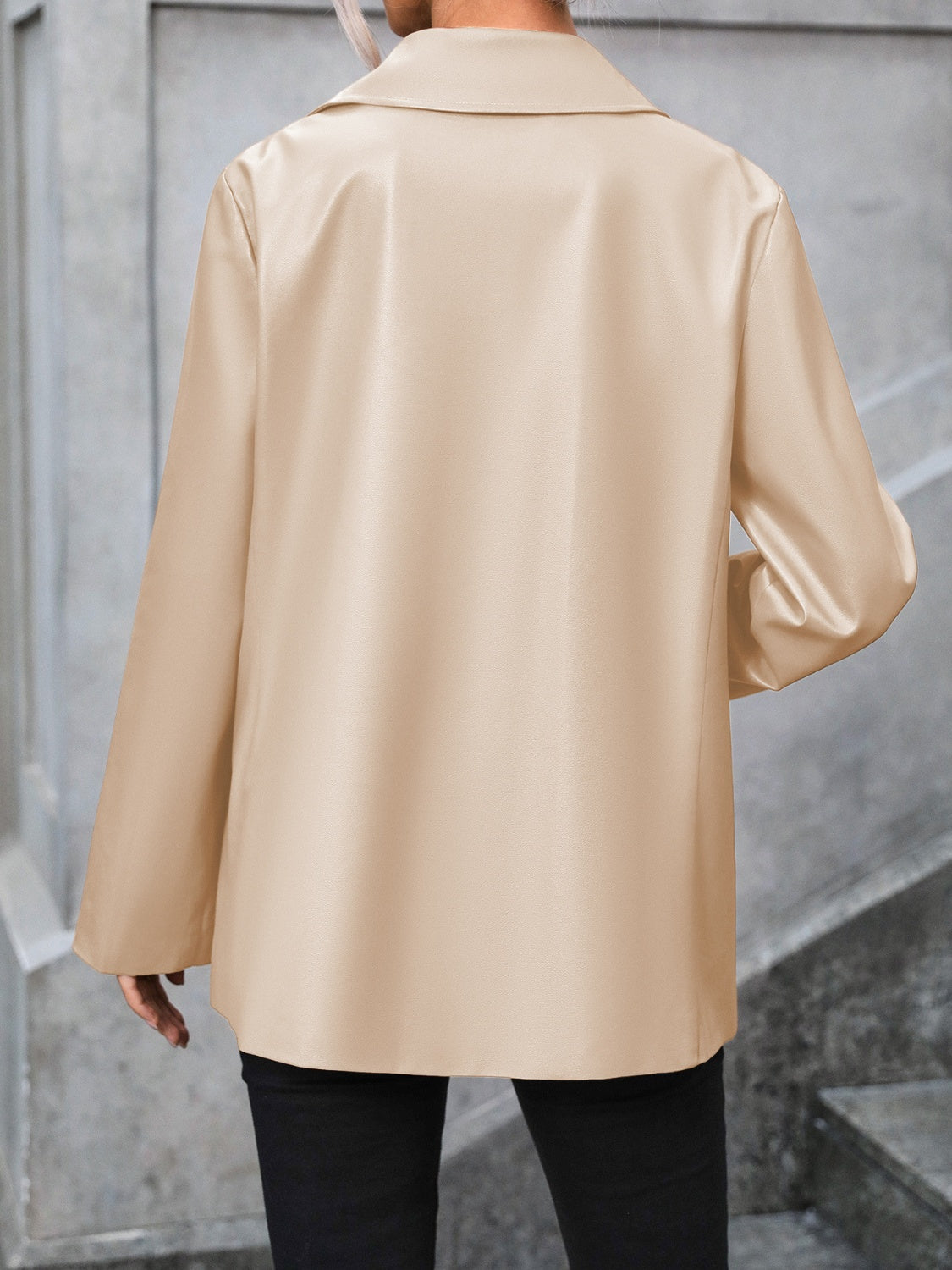 Tan faux leather tailored blazer with a classic collar and long sleeves.