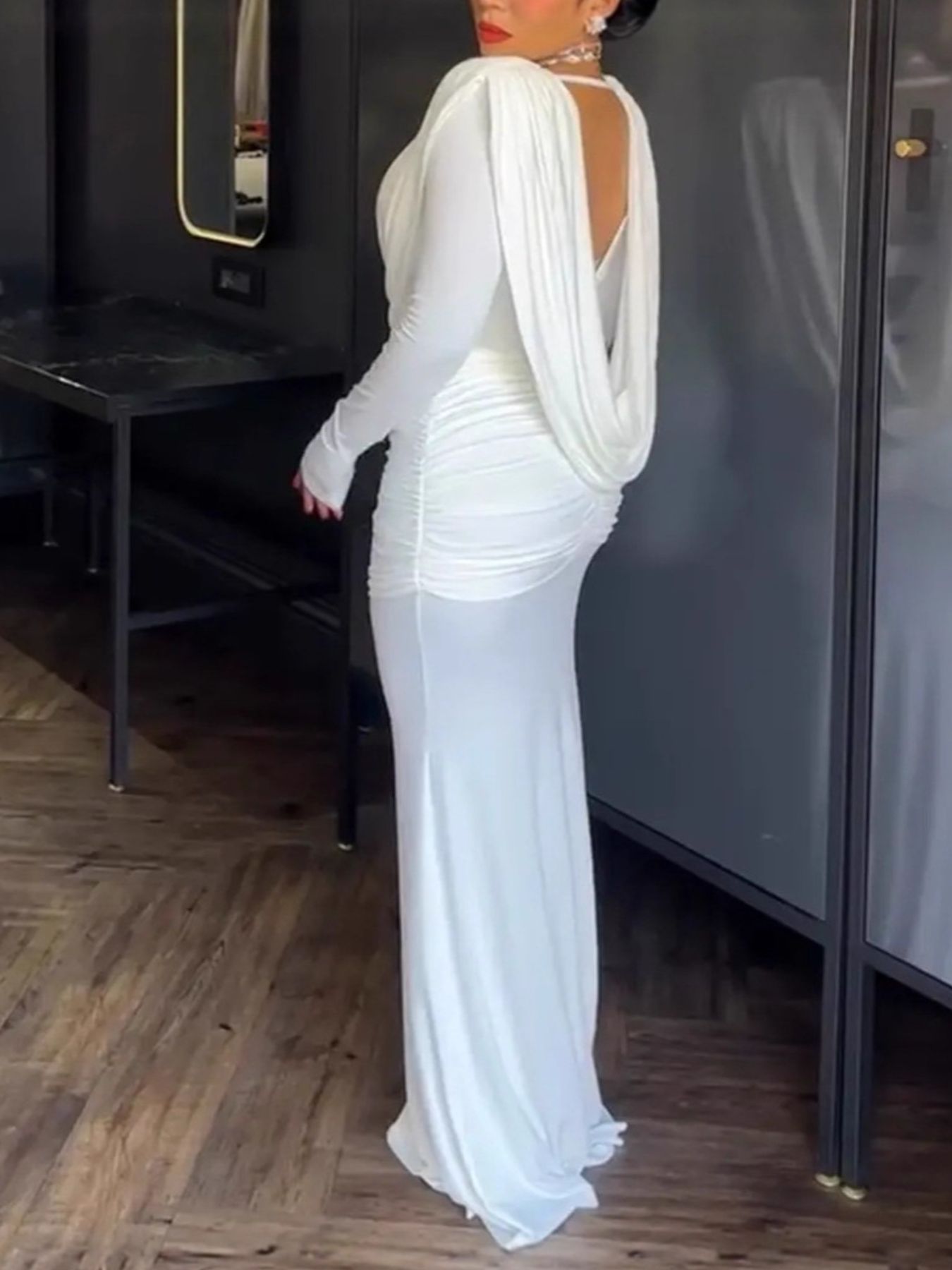 White ruched long-sleeve maxi dress with cowl neck and draped back detail.