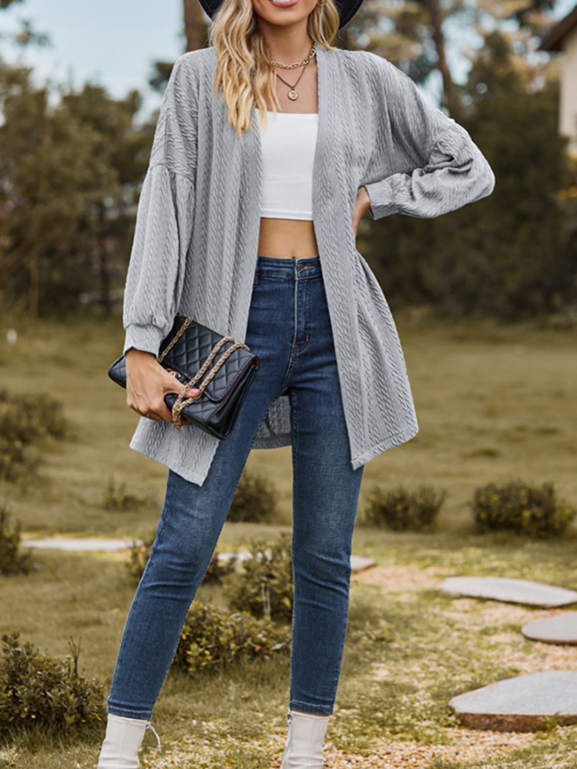 Gray textured open cardigan with balloon sleeves, worn with jeans and a white crop top.