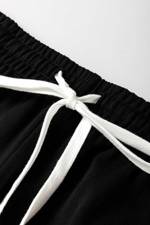 Black lounge pants with white drawstring and stripe detail