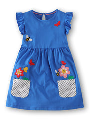 Blue cotton dress with ruffle sleeves, bird and flower appliques, and polka dot pockets.