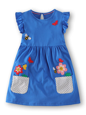 Blue cotton dress with ruffle sleeves, bird and flower appliques, and polka dot pockets.