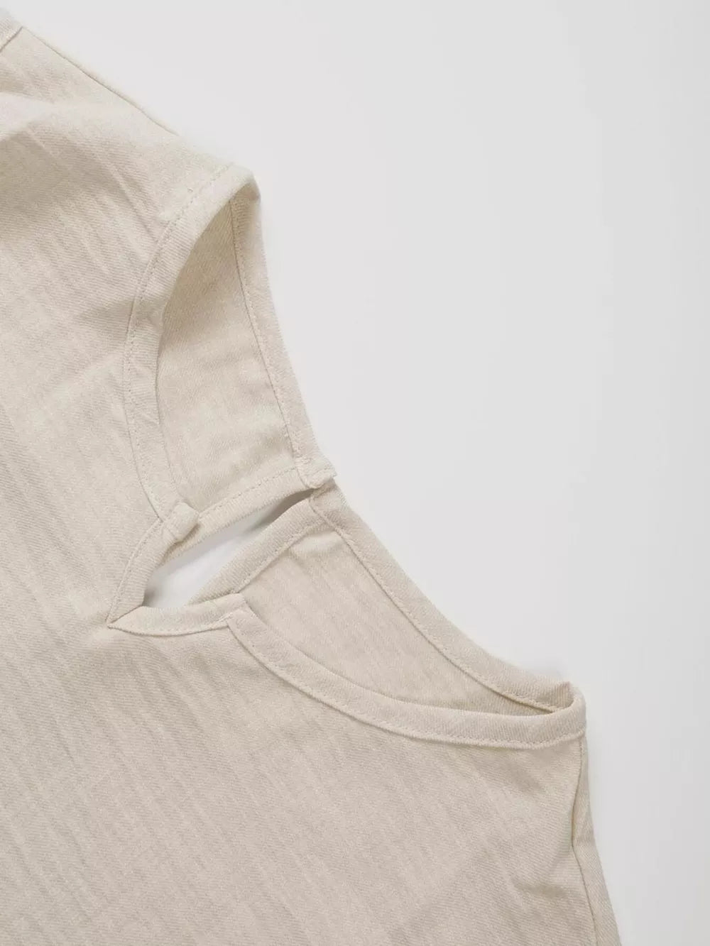 Textured beige two-piece set top with V-notch neckline and sleeveless cut.