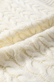 Ivory cable knit mock neck vest with chunky texture.