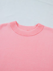 Pink knit top with crewneck and ribbed trim