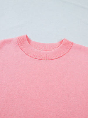 Pink knit top with crewneck and ribbed trim