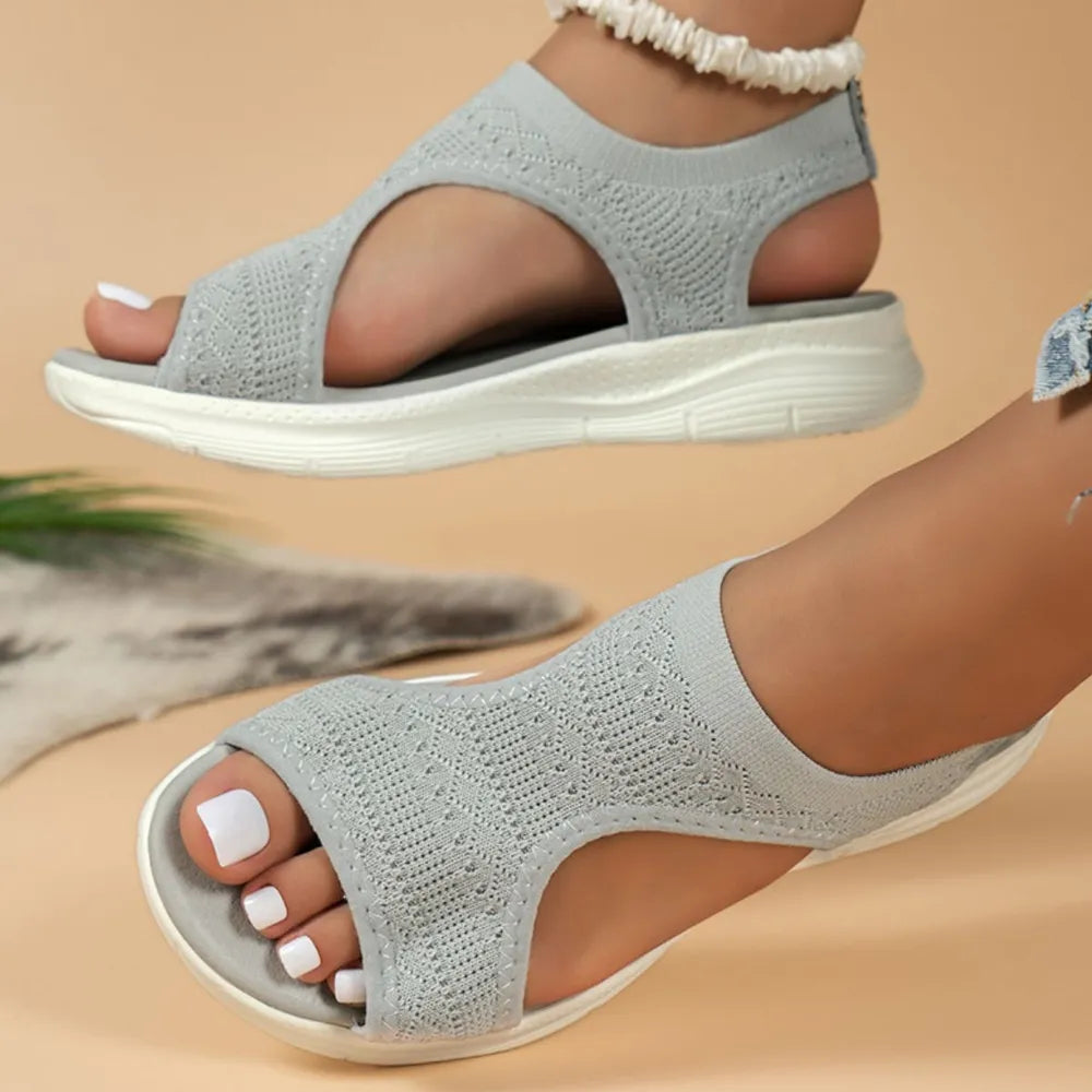 Light gray knit peep-toe sandals with a white platform sole.