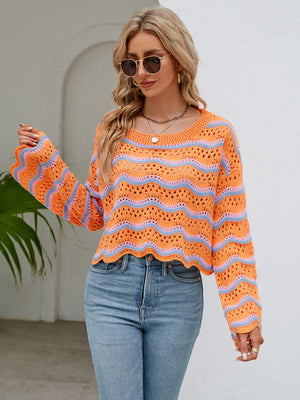 Orange and blue striped crochet crop sweater with scalloped hem and bell sleeves.
