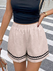 Beige casual shorts with elastic waist and wavy trim detail