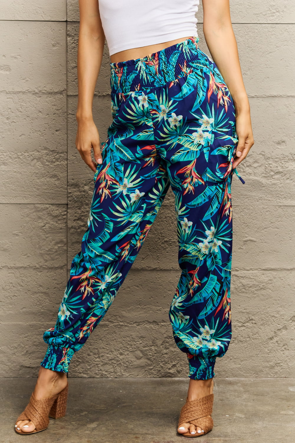 Tropical print cargo pants with gathered cuffs and smocked waistband.