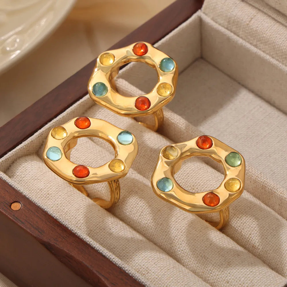 Gold statement ring with colorful gemstone halo detail