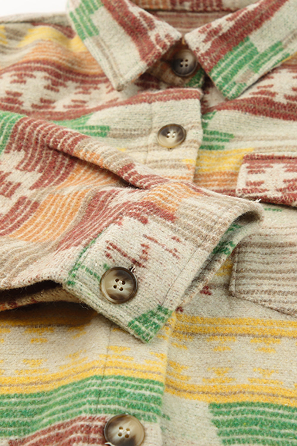 Shacket with Aztec print, button front, and patch pockets in tan with red, green, and yellow stripes.