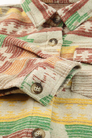 Shacket with Aztec print, button front, and patch pockets in tan with red, green, and yellow stripes.