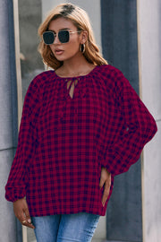 Burgundy plaid blouse with gathered neckline and tie detail, balloon sleeves.