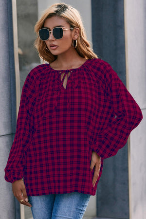 Burgundy plaid blouse with gathered neckline and tie detail, balloon sleeves.