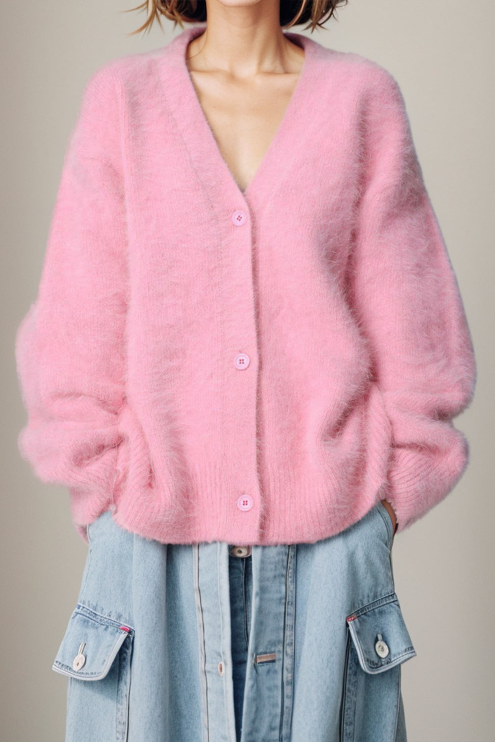 Fluffy angora V-neck cardigan in blush pink with button front and relaxed fit.