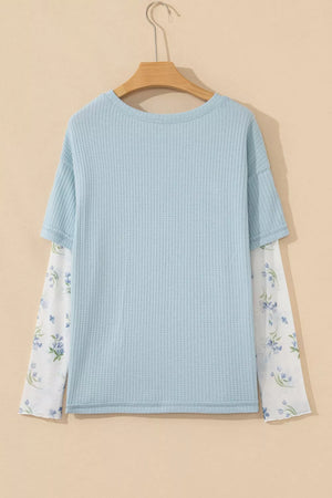 Light blue waffle knit maternity overshirt with floral print mesh sleeves.