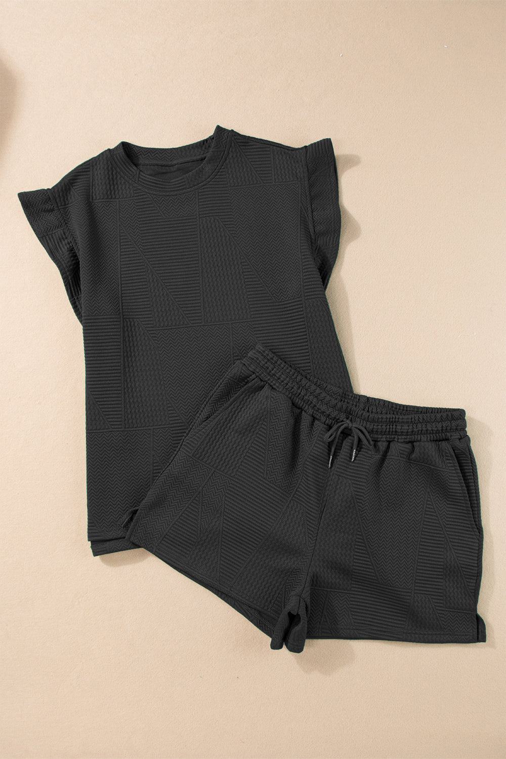 Black textured loungewear set with flutter sleeve top and drawstring shorts