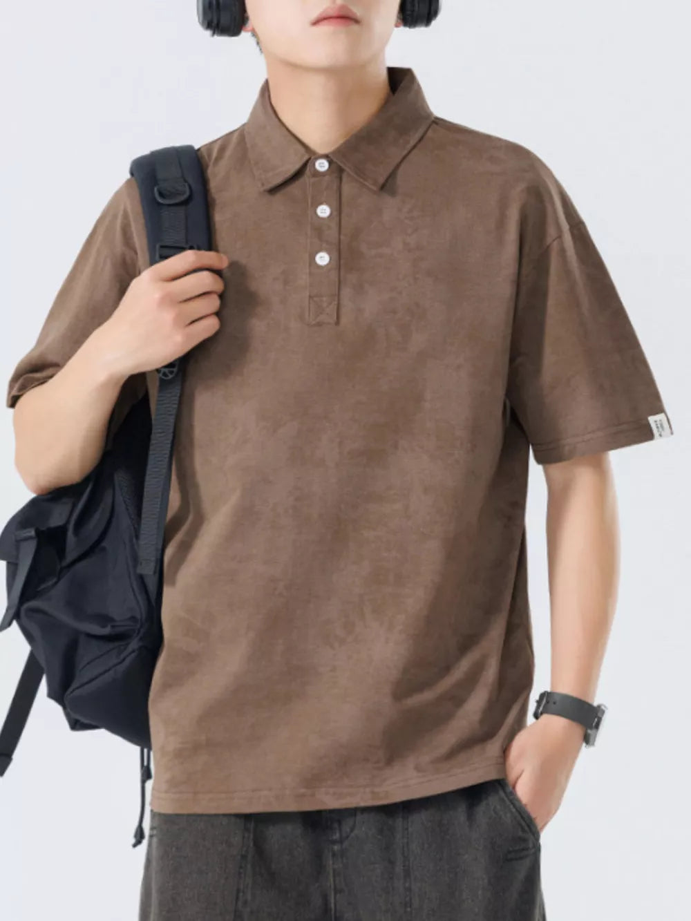 Brown cotton polo shirt with subtle texture and buttoned placket.