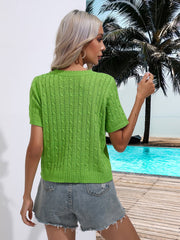 Green cable knit crew neck short sleeve sweater with detailed knit pattern.