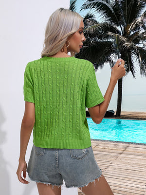 Green cable knit crew neck short sleeve sweater with detailed knit pattern.