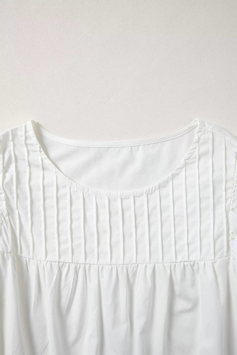 White cotton shirt with lace flutter sleeves and pleated front detail