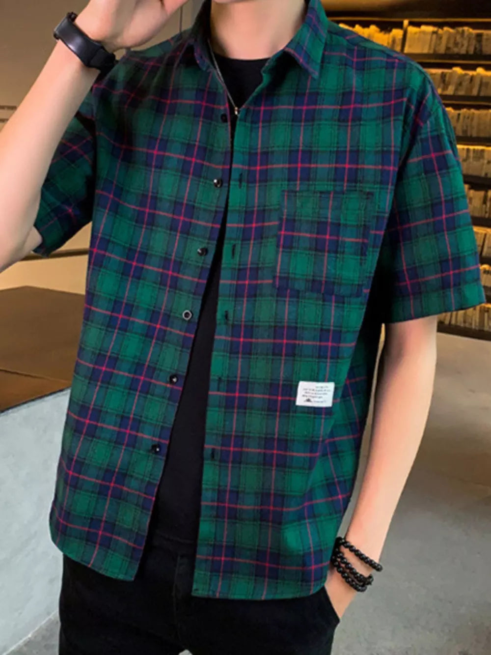 Green plaid short sleeve button-down shirt with chest pocket and cotton blend fabric.