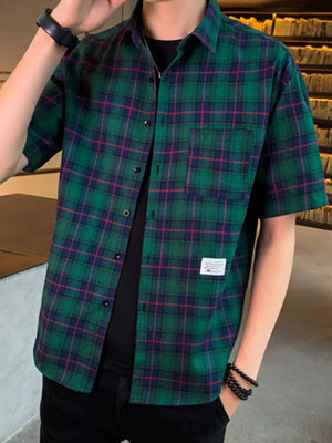Green plaid short sleeve button-down shirt with chest pocket and cotton blend fabric.