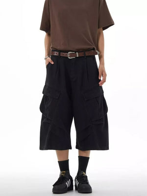 Black relaxed fit cargo capris with multiple pockets and a brown belt.
