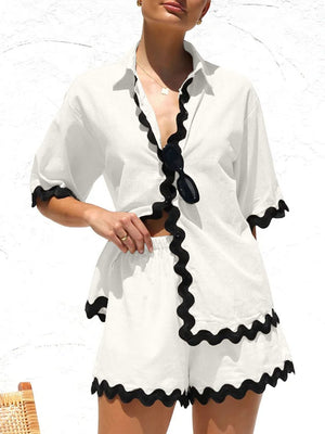 White linen co-ord set with black scalloped trim on shirt and shorts