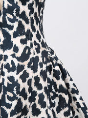Halter neck leopard print mini dress with a cutout detail.