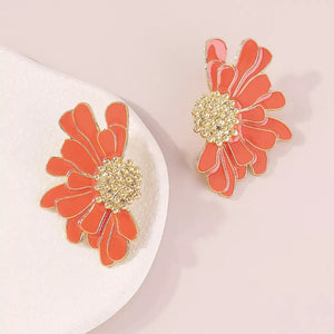 Textured orange flower stud earrings with gold centers.