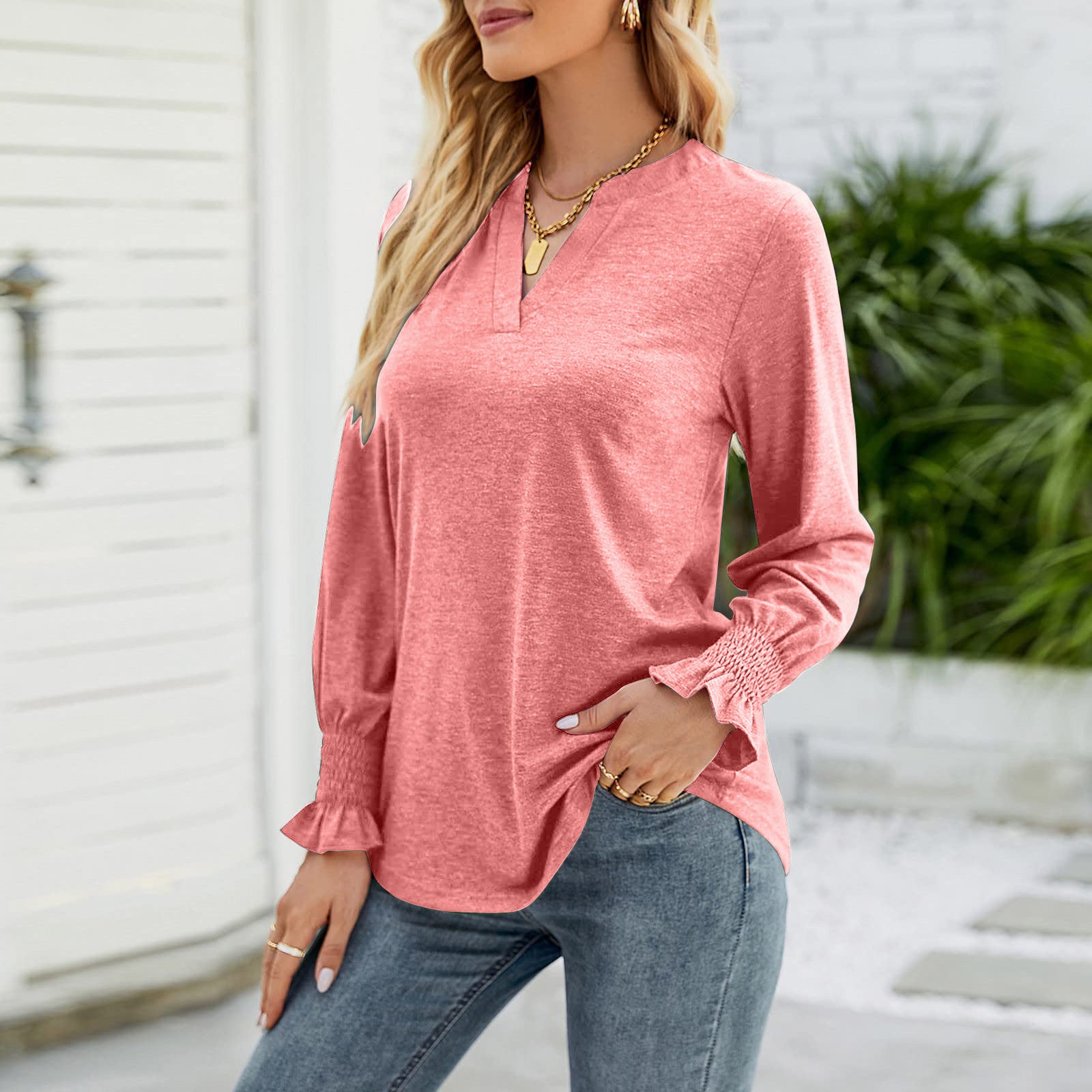 Burnt coral jersey v-neck top with gathered cuff long sleeves.