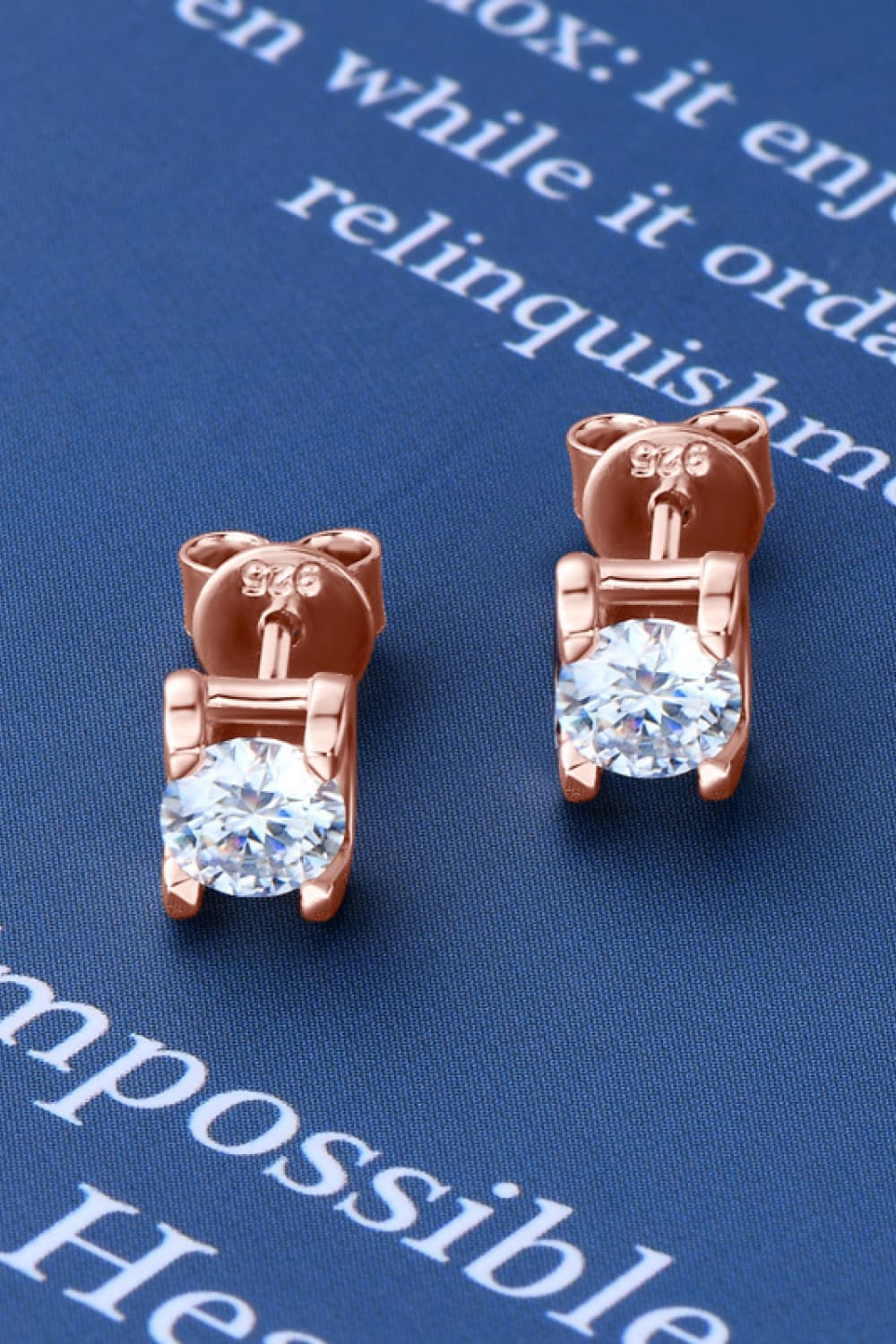 Rose gold moissanite solitaire stud earrings with 925 stamp detail.