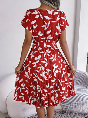 Crimson leaf print midi dress with pleated skirt and short sleeves.