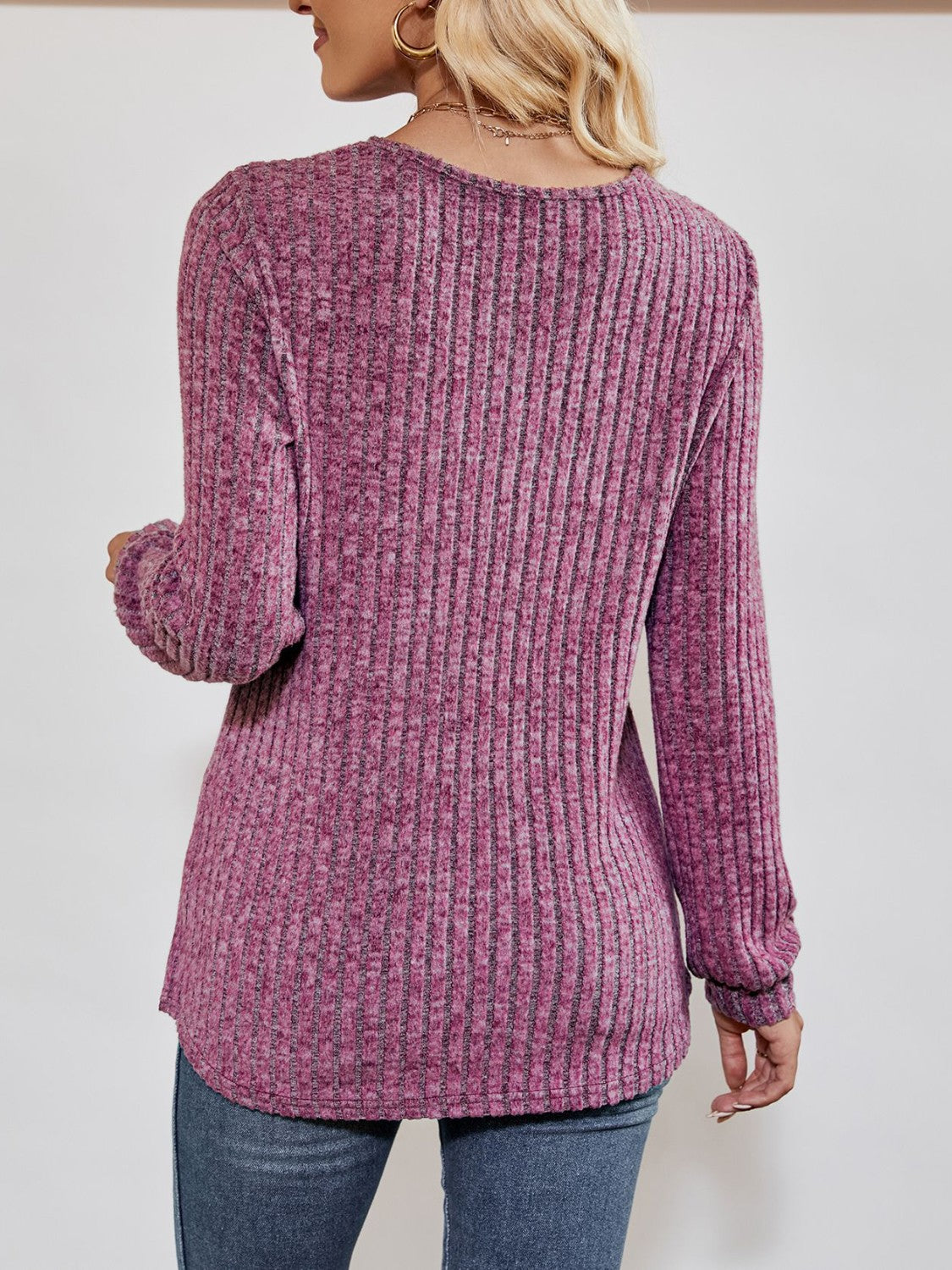 Textured ribbed V-neck pullover sweater in lilac with long sleeves.