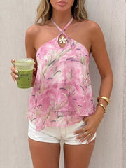 Vibrant floral halter cami with ruffle hem and flower detail at neckline.