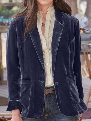 Peacock blue velvet blazer with rolled cuff detail and button closure.