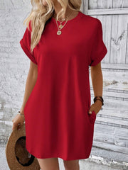 Red relaxed tee dress with cuffed sleeves and pockets, styled casually.