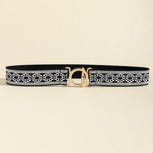 Black elastic belt with white lace trim and gold circle buckle