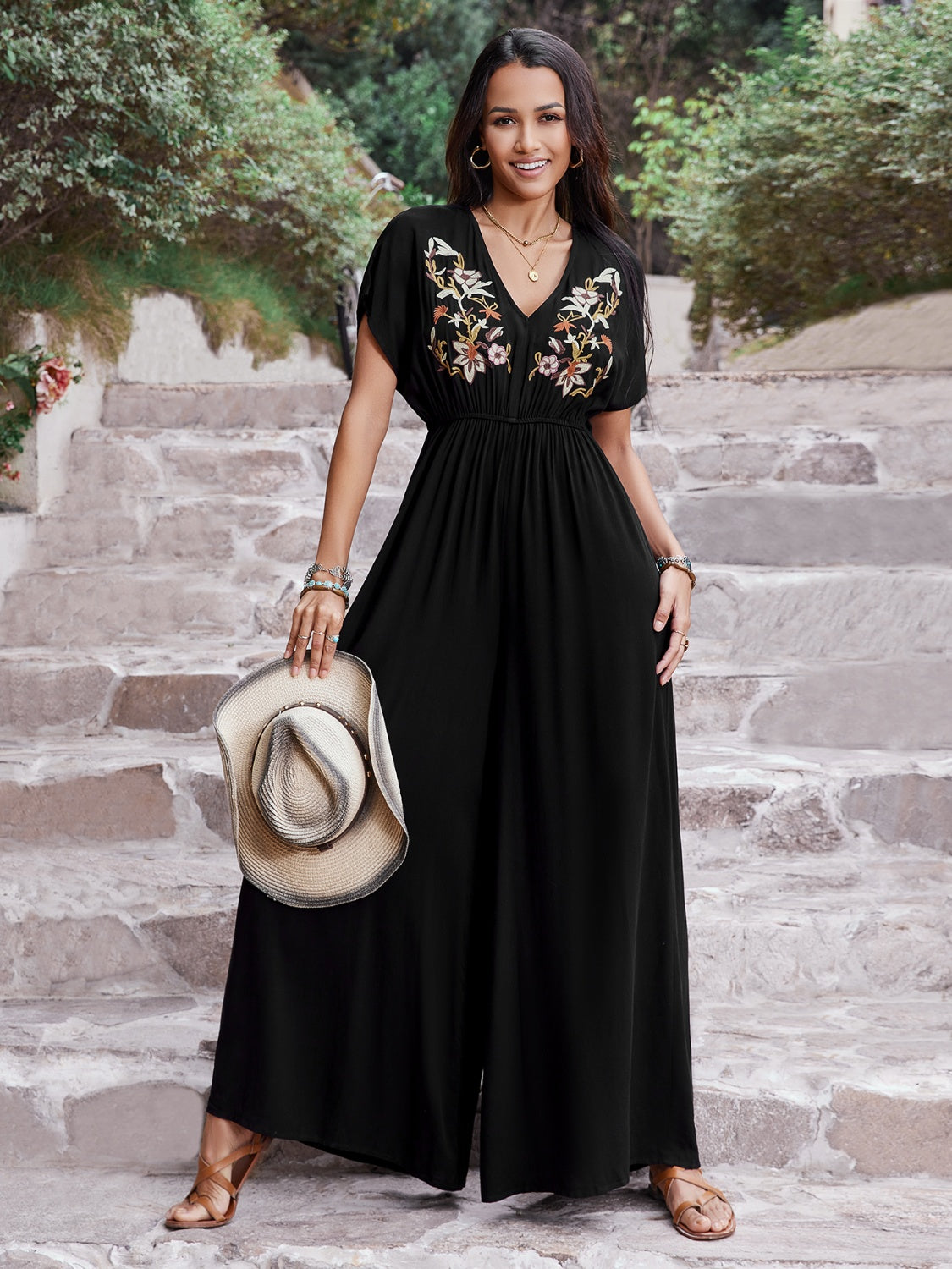 Black embroidered flutter sleeve wide-leg jumpsuit with V-neck and cinched waist.