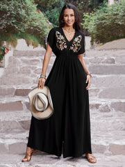 Black embroidered flutter sleeve wide-leg jumpsuit with V-neck and cinched waist.