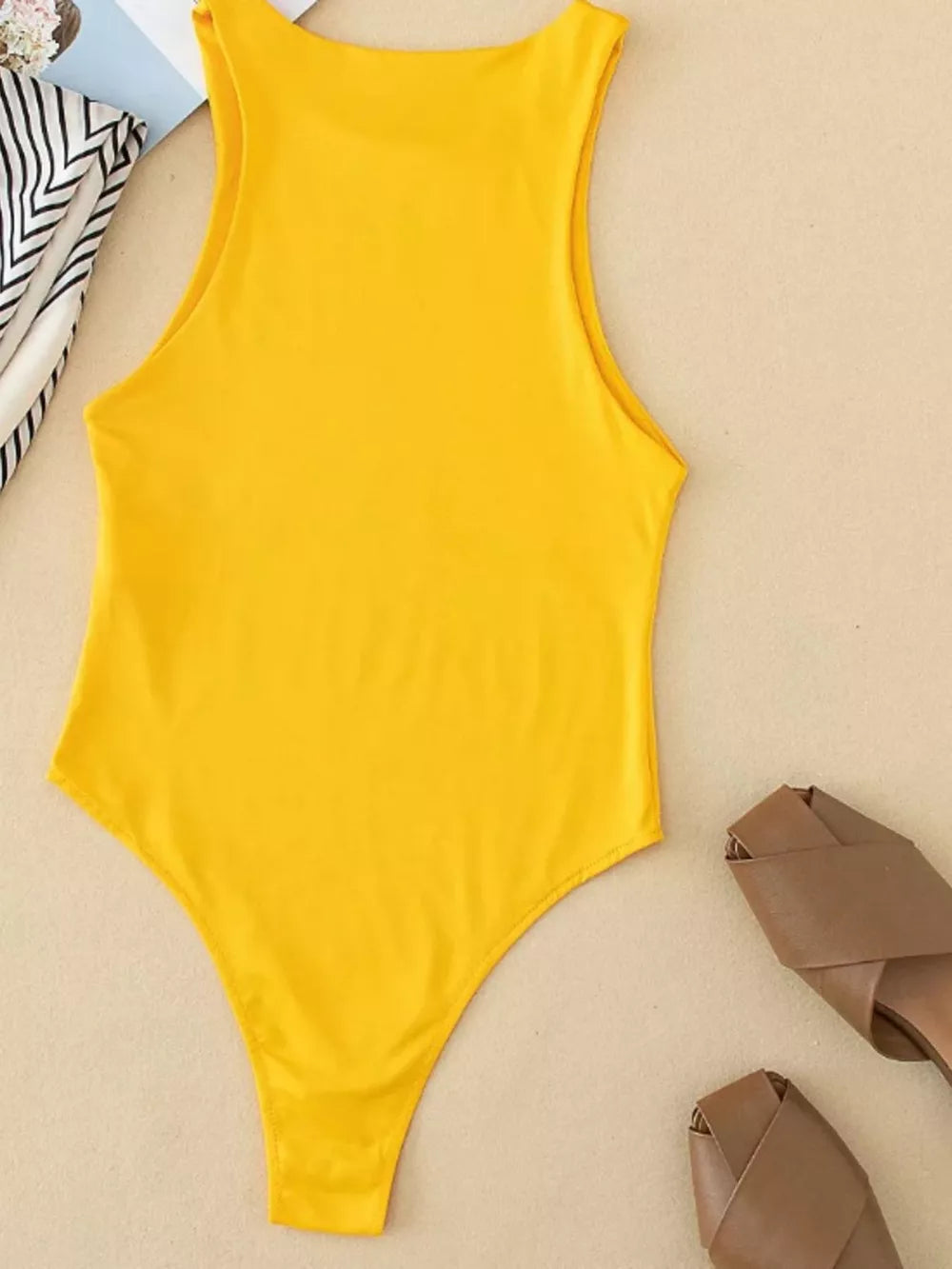 Yellow round neck sleeveless bodysuit with high cut leg