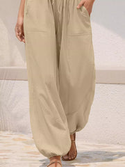 Relaxed harem maternity pants in apricot with drawstring and contrast stitching.