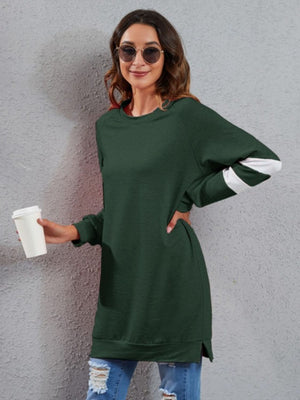 Dark Green sweatshirt dress with raglan sleeves and white varsity stripes on arms.