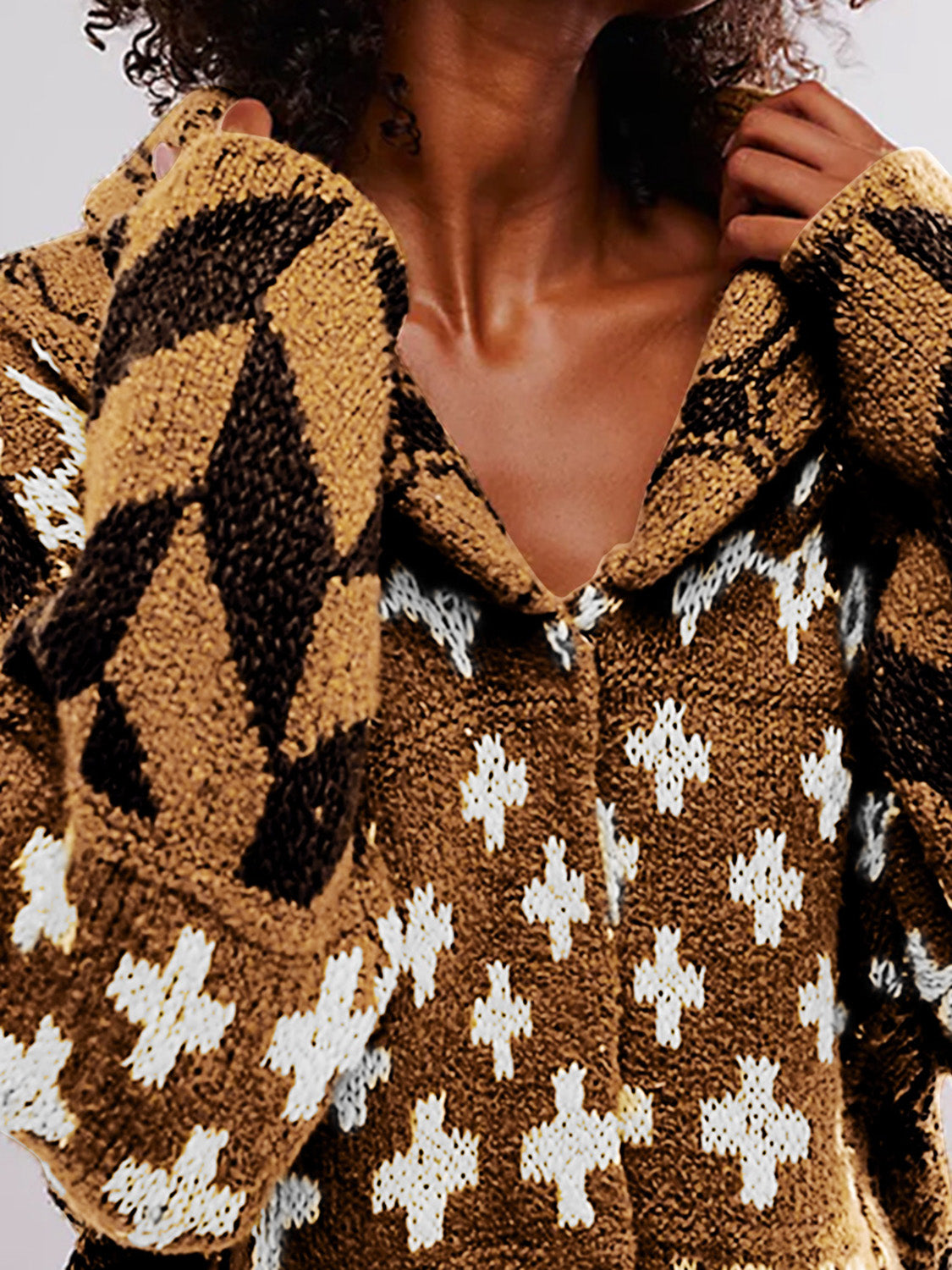 Geometric patchwork knit cardigan in brown with white cross and diamond patterns.