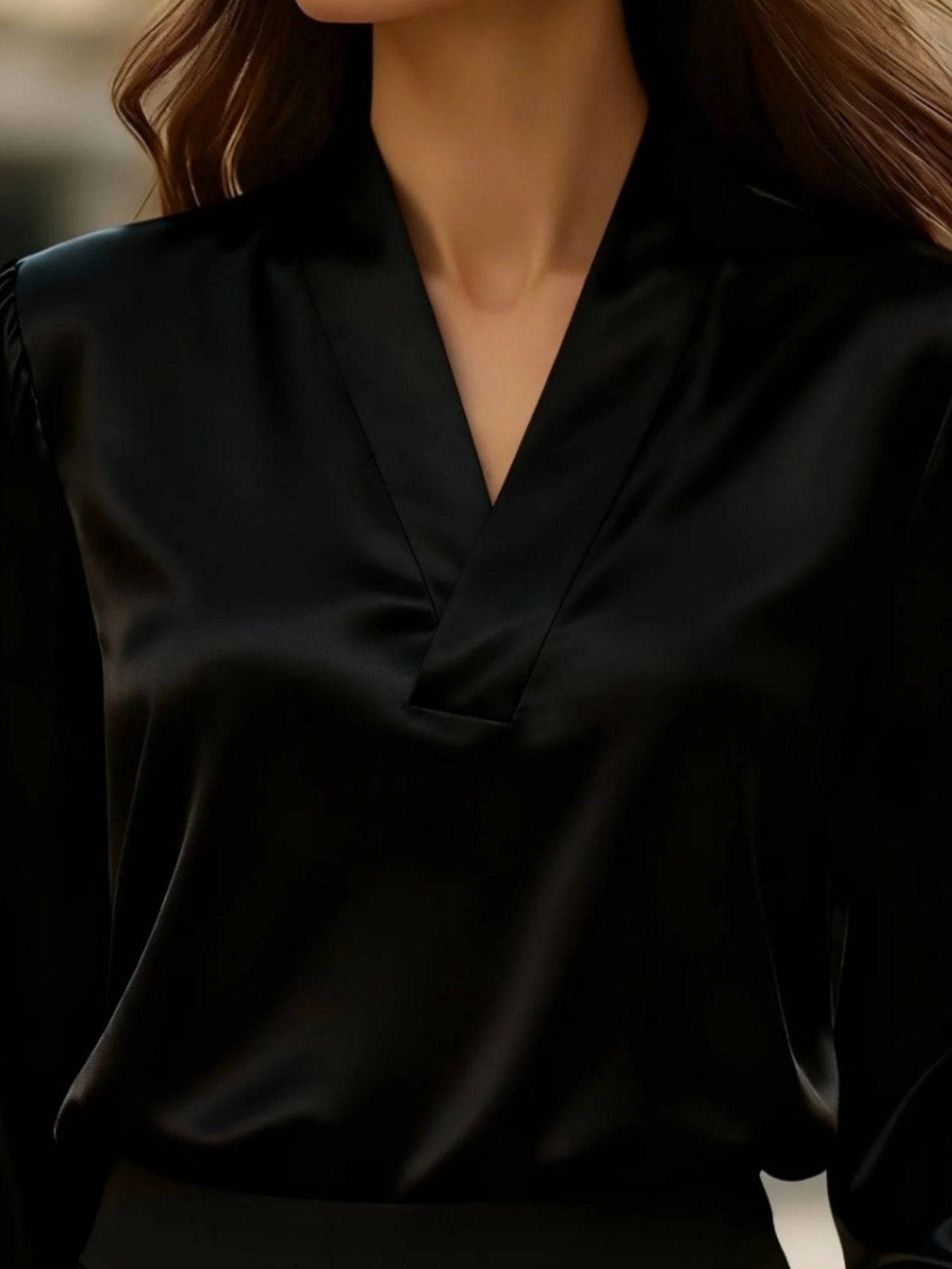 Black satin V-neck blouse with a relaxed fit and subtle sheen.