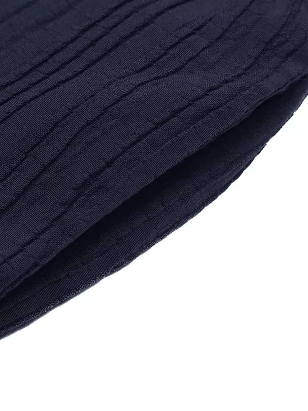Navy blue textured fabric detail of a ruffled peplum tube top and wide-leg pants set.